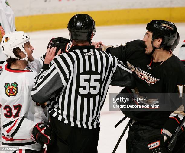 Adam Burish of the Chicago Blackhawks has words against George Parros of the Anaheim Ducks during the game on January 28, 2009 at Honda Center in...