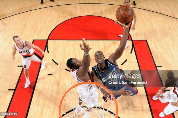Emeka Okafor of the Charlotte Bobcats goes up for a shot against Greg Oden of the Portland Trail Blazers during a game at the Rose Garden Arena...
