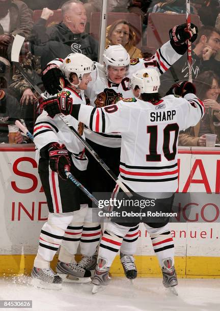 Patrick Sharp and Duncan Keith of the Chicago Blackhawks celebrate a goal from teammate Jonathan Toews a second period the Anaheim Ducks during the...