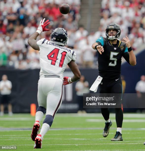 Blake Bortles of the Jacksonville Jaguars thows a pass in the first quarter defended by Zach Cunningham of the Houston Texans at NRG Stadium on...
