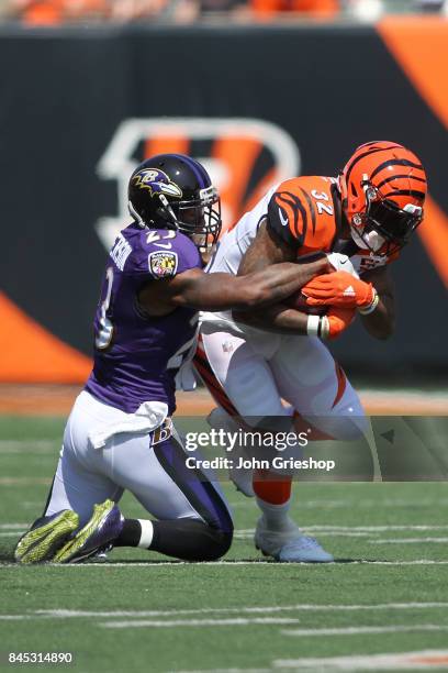 Jeremy Hill of the Cincinnati Bengals is tackled by Tony Jefferson of the Baltimore Ravens during the first quarter at Paul Brown Stadium on...
