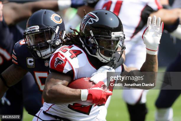 Devonta Freeman of the Atlanta Falcons carries the football against Jerrell Freeman of the Chicago Bears in the first quarter at Soldier Field on...