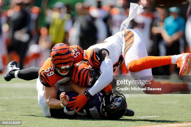 Nick Vigil of the Cincinnati Bengals and George Iloka of the Cincinnati Bengals combine to tackle Danny Woodhead of the Baltimore Ravens during the...