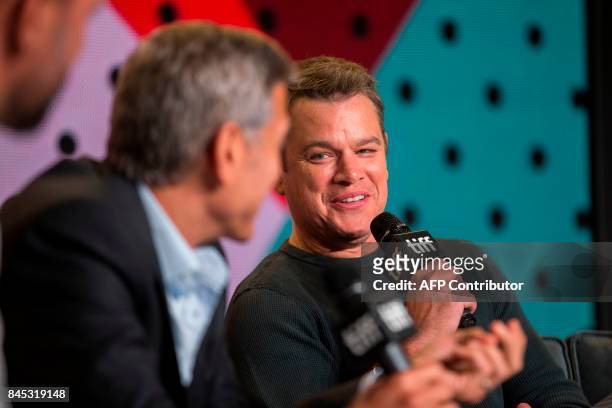 Matt Damon jokes with director George Clooney during the press conference for 'Suburbicon' at the Toronto International Film Festival in Toronto,...