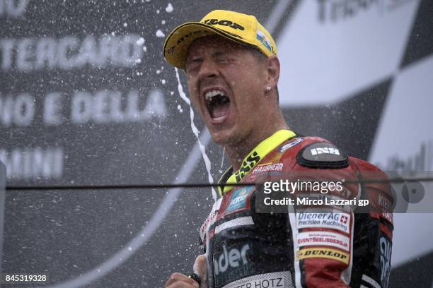 Dominique Aegerter of Switzerland and Kiefer Racing celebrates the victory on the podium at the end of the Moto2 Race during the MotoGP of San Marino...