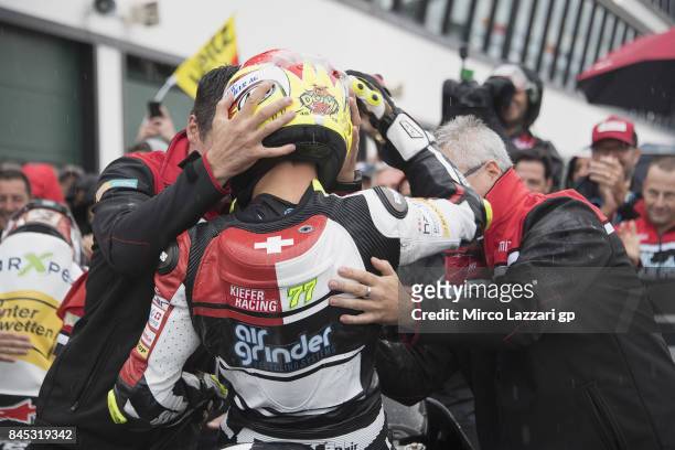 Dominique Aegerter of Switzerland and Kiefer Racing celebrates the victory with team under the podium at the end of the Moto2 Race during the MotoGP...