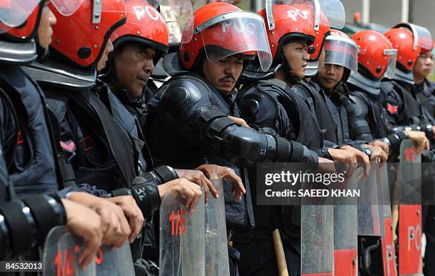 Malaysian Police stand in formation at a hospital grounds in Kuala Lumpur on January 28, 2009. Malaysian police arrested five people as large crowds...