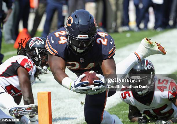 Jordan Howard of the Chicago Bears dives into the end zone for a touchdown past Desmond Trufant and Deion Jones of the Atlanta Falcons during the...