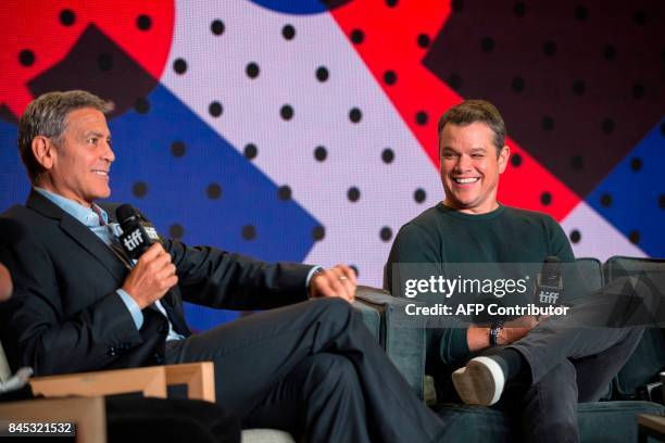 Matt Damon laughs as Director George Clooney speaks during the press conference for 'Suburbicon' at the Toronto International Film Festival in...