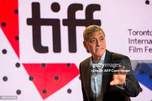 George Clooney waves following the press conference for 'Suburbicon' at the Toronto International Film Festival in Toronto, Ontario on September 10,...