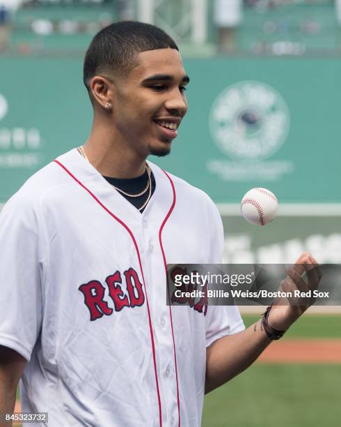 Boston Celtics first round draft pick Jayson Tatum tosses the ball after throwing out the ceremonial first pitch before a game between the Boston Red...
