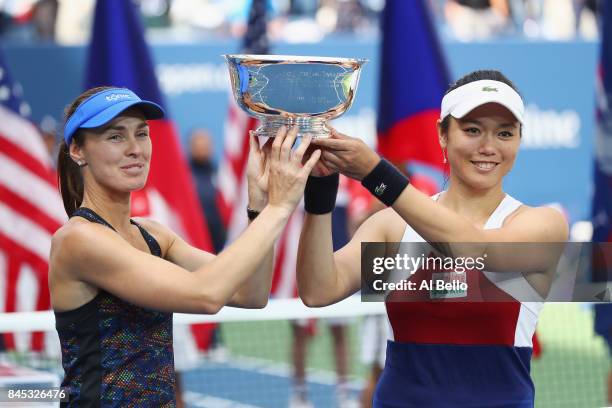 Martina Hingis of Switzerland and Yung-Jan Chan of Taiwan hold the championship trophy after defeating Lucie Hradecka of Czech Republic and Katerina...