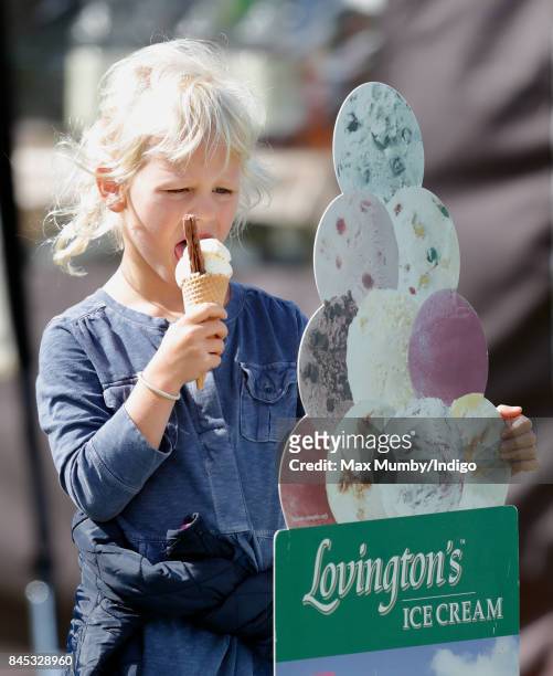 Isla Phillips eats an ice cream as she attends the Whatley Manor Horse Trials at Gatcombe Park on September 9, 2017 in Stroud, England.