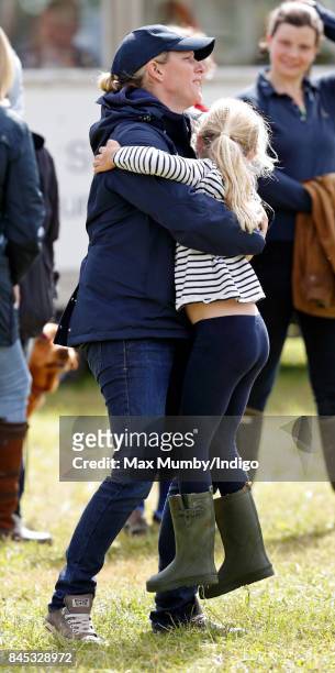 Zara Phillips hugs her niece Savannah Phillips as they attend the Whatley Manor Horse Trials at Gatcombe Park on September 9, 2017 in Stroud, England.