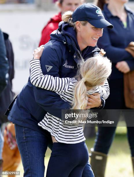 Zara Phillips hugs her niece Savannah Phillips as they attend the Whatley Manor Horse Trials at Gatcombe Park on September 9, 2017 in Stroud, England.