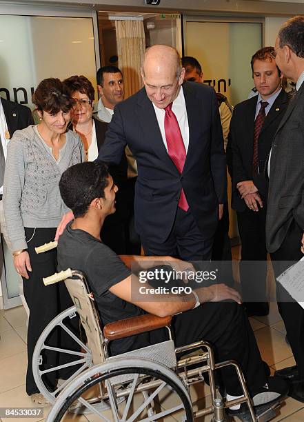 In this handout image provided by the GPO , Prime Minister Ehud Olmert visits a wounded soldier at the Tel Hashomer hospital on January 29, 2009 in...