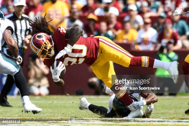 Washington Redskins running back Rob Kelley is tripped up by Philadelphia Eagles defensive back Patrick Robinson in the second quarter on September...