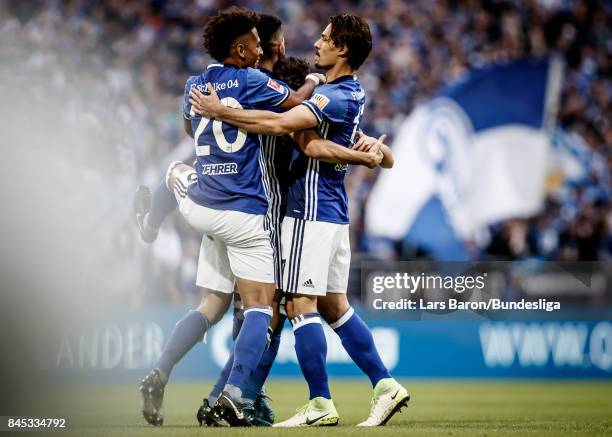 Nabil Bentaleb of Schalke celebrates with team mates after scoring his teams first goal during the Bundesliga match between FC Schalke 04 and VfB...