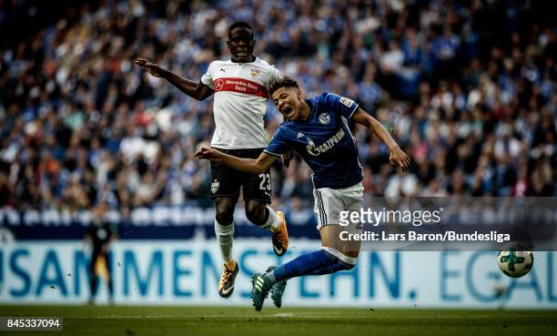 Orel Mangala of Stuttgart challenges Amine Harit of Schalke during the Bundesliga match between FC Schalke 04 and VfB Stuttgart at Veltins-Arena on...
