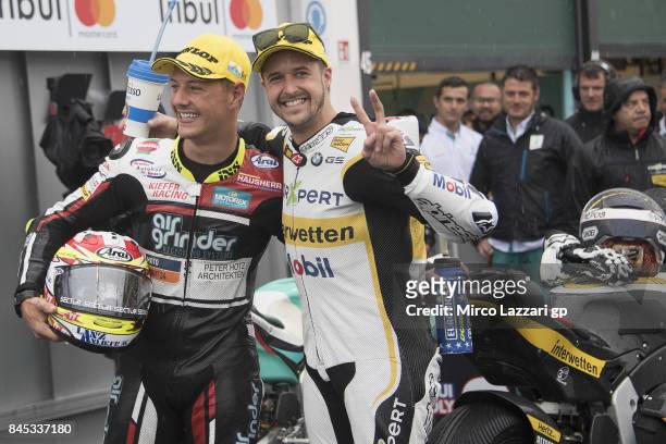 Dominique Aegerter of Switzerland and Kiefer Racing and Thomas Luthi of Switzerland and Carxpert Interwetten celebrate under the podium at the end of...