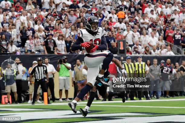 DeAndre Hopkins of the Houston Texans catches a pass for a touchdown defended by Jalen Ramsey of the Jacksonville Jaguars during the third quarter at...