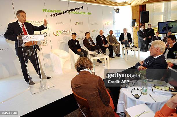 Former British Prime Minister Tony Blair talks as former US President Bill Clinton listens in Davos on January 29, 2009 during the Davos...