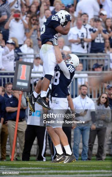 Penn State TE Mike Gesicki lifts up RB Saquon Barkley after a touchdown. The Penn State Nittany Lions defeated the Pittsburgh Panthers 33-14 in the...
