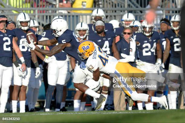 Penn State WR DaeSean Hamilton pulls in the ball after making a one-handed catch along the sidelines as Pitt S Jazzee Stocker tackles him. The Penn...