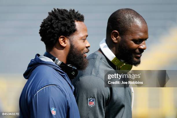 Michael Bennett of the Seattle Seahawks talks with brother Martellus Bennett of the Green Bay Packers before their game at Lambeau Field on September...