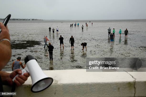 Residents inspect the extreme receding water in Tampa Bay ahead of Hurricane Irma on September 10, 2017 in Tampa, Florida. Hurricane Irma made...