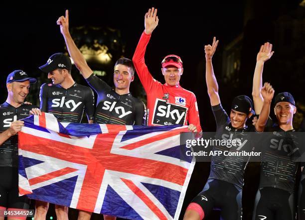 Team Sky's British cyclist Chris Froome holds a Union Jack with the rest of his team as he celebrates on the podium winning the 72nd edition of "La...