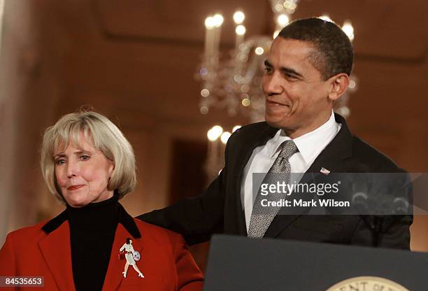 President Barack Obama hugs Lilly Ledbetter before signing the "Lilly Ledbetter Fair Pay Act duringn an event in the East Room of the White House...