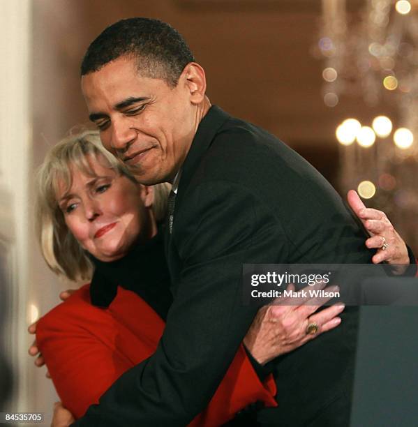President Barack Obama hugs Lilly Ledbetter before signing the "Lilly Ledbetter Fair Pay Act duringn an event in the East Room of the White House...