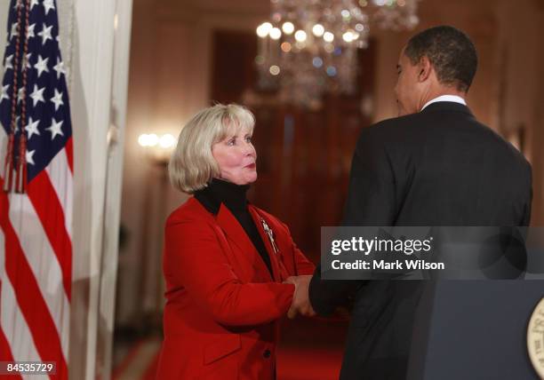 President Barack Obama shakes hands with Lilly Ledbetter before signing the "Lilly Ledbetter Fair Pay Act during an event in the East Room of the...