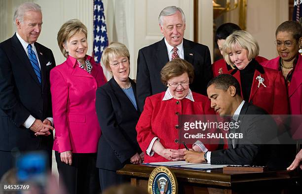 President Barack Obama, surrounded by lawmakers, US Vice President Joe Biden , US Secretary of State Hillary Clinton Sen. Barbara Mikulski D-MD,...