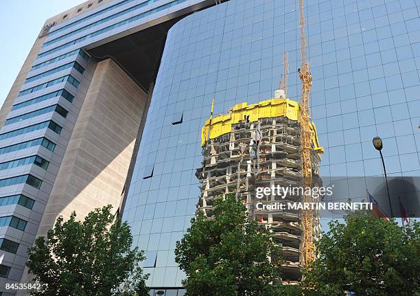 Building of the "Costanera Center" project is reflected on another building in Santiago, on January 29, 2009. The construction of the architectural...