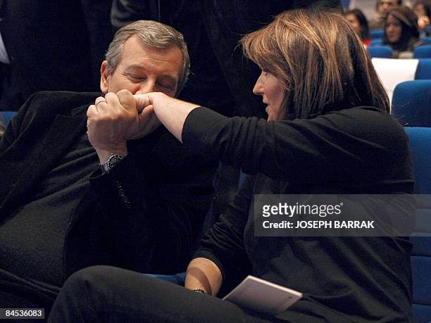 Richard Attias kisses the hand of his wife Cecilia as they attend the MENA Cristal Awards ceremony at the Mzaar 2000 resort in Oyoun al-Siman,...