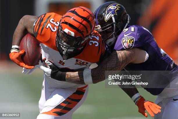 Jeremy Hill of the Cincinnati Bengals is tackled by Kamalei Correa of the Baltimore Ravens during the third quarter at Paul Brown Stadium on...