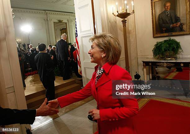 Secretary of State Hillary Clinton greets a quest while attending the "Lilly Ledbetter Fair Pay Act bill signing at the White House January 29, 2009...
