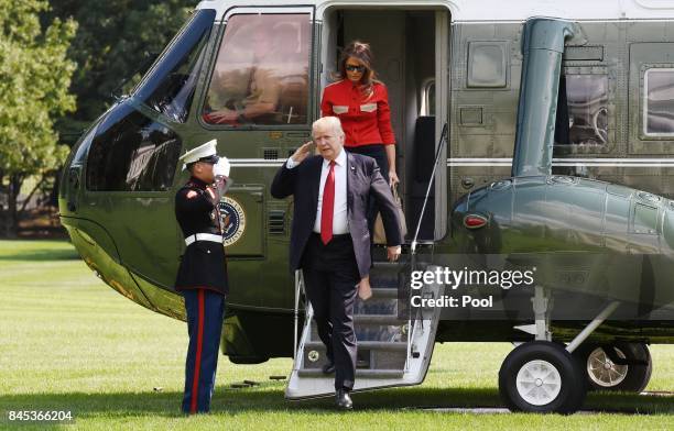 President Donald Trump and First Lady Melania Trump walk from Marine One upon arrival on the South Lawn of the White House September 10, 2017 in...