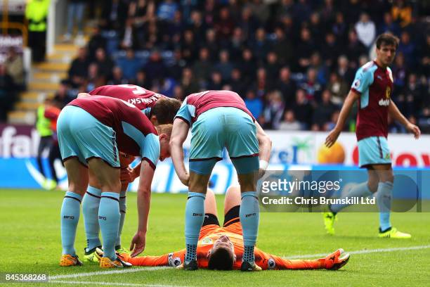 Tom Heaton of Burnley lies injured during the Premier League match between Burnley and Crystal Palace at Turf Moor on September 10, 2017 in Burnley,...