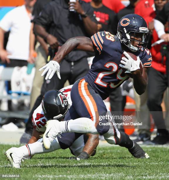 Tarik Cohen of the Chicago Bears moves around Duke Riley of the Atlanta Falcons during the season opening game at Soldier Field on September 10, 2017...