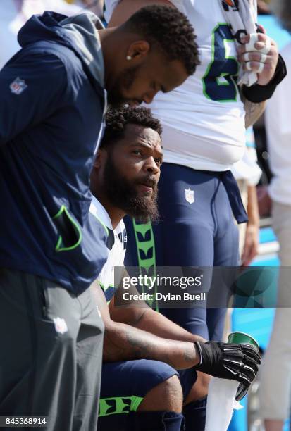 Michael Bennett of the Seattle Seahawks sits on the bench during the national anthem prior to the game against the Green Bay Packers at Lambeau Field...