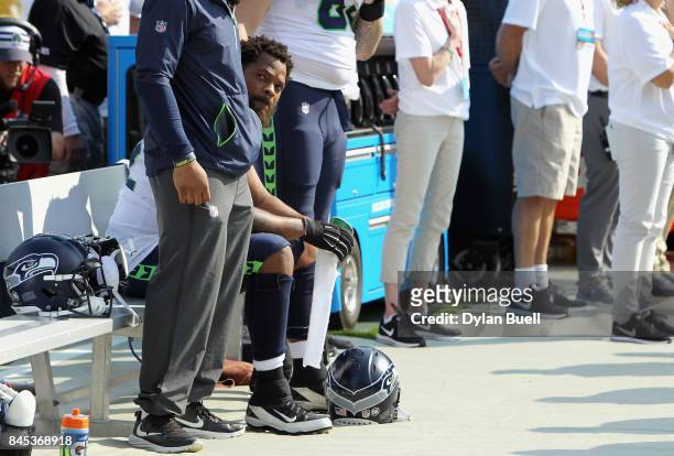 Michael Bennett of the Seattle Seahawks sits on the bench during the national anthem prior to the game against the Green Bay Packers at Lambeau Field...