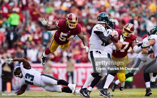 Mason Foster of the Washington Redskins flys in the air to tackle Quarterback Carson Wentz of the Philadelphia Eagles in the fourth quarter at...