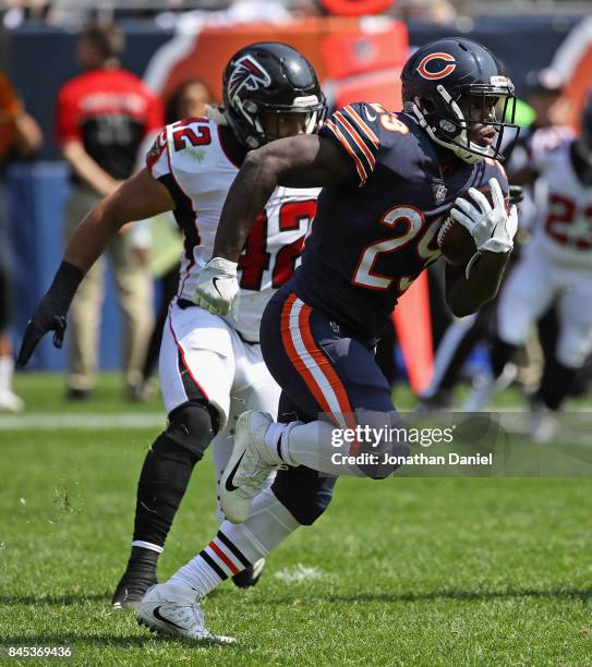 Tarik Cohen of the Chicago Bears moves past Duke Riley of the Atlanta Falcons during the season opening game at Soldier Field on September 10, 2017...