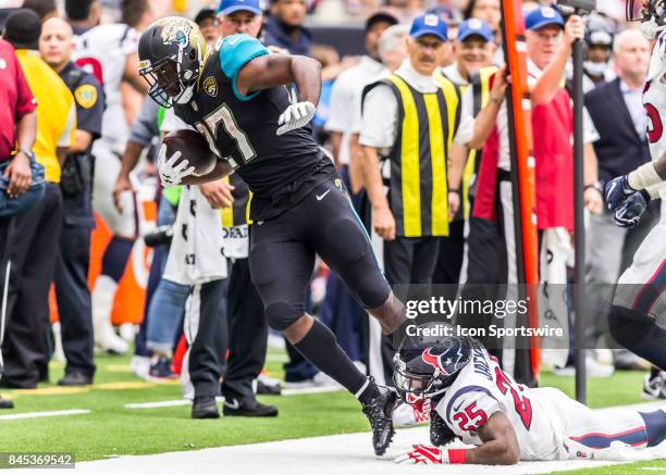 Jacksonville Jaguars running back Leonard Fournette gets pushed out of bounds by Houston Texans cornerback Kareem Jackson during the NFL game between...