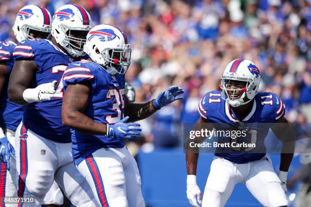 Mike Tolbert of the Buffalo Bills is greeted by teammates after scoring a touchdown during the second half against the New York Jets on September 10,...