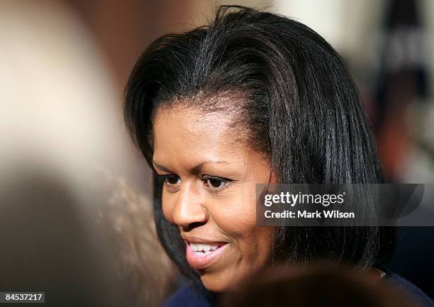 First lady Michelle Obama attends the "Lilly Ledbetter Fair Pay Act" bill signing in the East Room of the White House January 29, 2009 in Washington,...