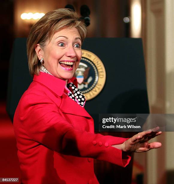 Secretary of State Hillary Clinton waves as she arrives at the "Lilly Ledbetter Fair Pay Act" bill signing in the East Room of the White House...